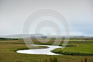 Still river among green hills in Iceland