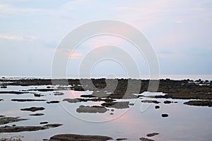 Still Sea Water during Low Tide at Littoral Zone - Pinkish Blue Clear Morning Sky with Reflection in Water - Natural Background photo