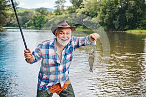 Still water trout fishing. Fishes catching hooks. Fisherman and trophy trout. Rainbow trout on a hook. Fishing became a