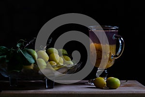 Stilllife with fresh yellow plums and glass of home made plum limonade