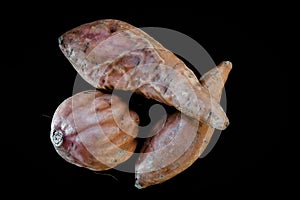 Stilllife - Three pieces of sweet potatoes in front of a dark background