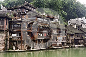 Stilt architecture elevate houses above flood surface in water cities such as Fenghuang Ancient City, built on the Tuo Jiang River