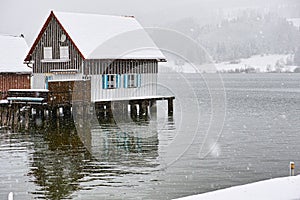 Stilt house at lake by snow flurry