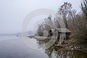 stilt houses on the lake on a foggy day