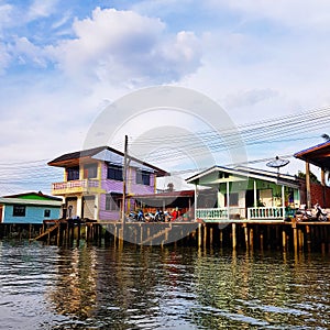 Stilt houses at riverside in Thailand