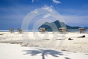 Stilt huts on tropical beach