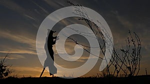 Stilt Walker Jumping at Sunset. Beautiful Action in Slow Motion.