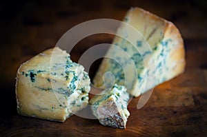 Stilton mature blue mouldy cheese - Dark background photo