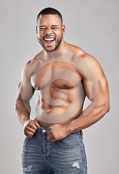 Stimulate dont annihilate. Studio shot of a young muscular man posing against a grey background.