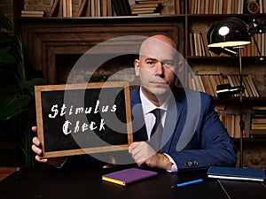 Stimulus Check phrase on chalkboard