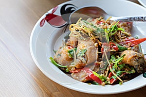 Stir deep fried fish with spicy herbs photo