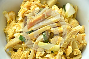 stir fried bamboo shoot and egg with spring onion on bowl