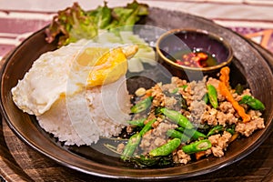 Stir-fried basil or Pad Kra Pao with fried eggs and fish sauce chili is a popular Thai food