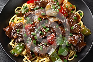 Stir fried beef in black bean sauce with vegetables and noodles. Take away food