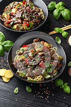 Stir fried beef in black bean sauce with vegetables and noodles. Take away food