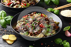 Stir fried beef in black bean sauce with vegetables and noodles. Take away food