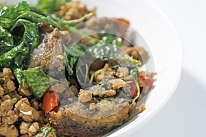 Stir Fried Century egg with Crispy Basil on plate