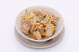 Stir-fried Chicken with Ginger in a white dish on a white isolated background. Thai food. Top view.