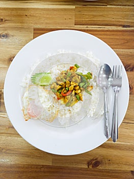 Stir-fried chicken with roasted curry paste and sweet basil leaf, lentils mixed vegetables, Fried egg on jasmine rice in white