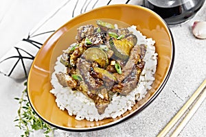 Stir-fried of chicken with zucchini in plate on granite table