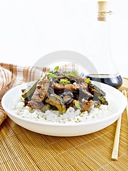 Stir-fried of chicken with zucchini in plate on wooden board