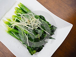 Stir fried Chinese Hong Kong kale with sliced ginger.