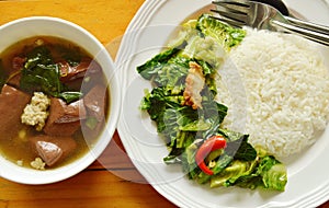 Stir fried Chinese kale sprout with crispy pork and ivy gourd soup photo