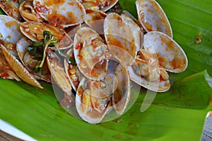 Stir fried clams with roasted chili paste on fresh banana leaf