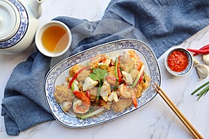 Stir-fried fish maw with prawn and crabmeat - Thai Chinese food flat lay on the marble table