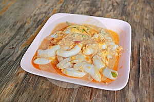 Stir fried fresh squid with yoke eggs, onion and chilli