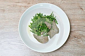 Stir fried garlic chives with pork liver on plate