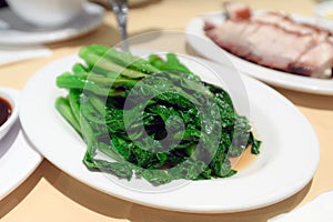 Stir fried green vegetable on white plate