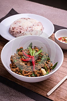 Stir fried minced pork with basil served with steamed jasmin rice and Riceberry, Pad kra pao