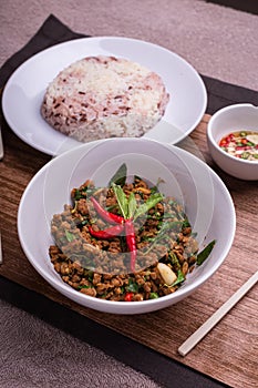 Stir fried minced pork with basil served with steamed jasmin rice and Riceberry, Pad kra pao