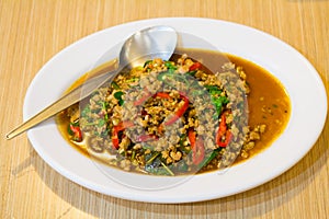 stir-fried with minced pork and basil on white plate (Ka Prao Mo