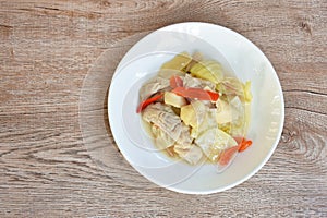 Stir fried pickled cabbage with pork innards and stomach and chili on plate