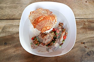 stir fried pork or deep fried pork , fried pork or crispy pork and rice with fried egg or sunny side up egg or pork and rice photo