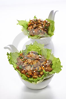 Stir fried pork serve with lettuce