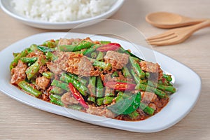 Stir fried pork with yard long bean and red curry paste served with rice, Thai food