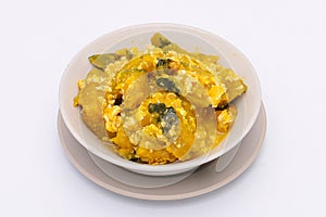 Stir-Fried Pumpkin with Egg in a white dish on a white isolated background. Thai food. Top view.