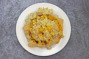 Stir Fried Pumpkin with Egg, on white plate top view, Thai dishes