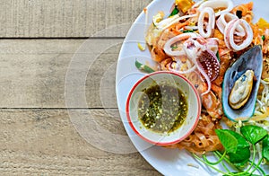 Stir-fried rice noodles Pad Thai with shrimp, mussels and squid