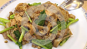 Stir-fried Rice Noodles with Soy Sauce and Pork - Asian food style. Fried Noodle in Soy Sauce. stir fried large rice noodles