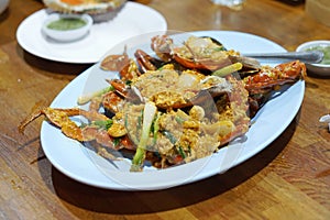 Stir-Fried Sea Crab with Curry Powder Sauce, Milk and Eggs. A popular Thai-Chinese seafood.