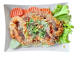 Stir Fried Shrimp with Garlic and Pepper, serving with fresh carrot and cucumber. Traditional Thai Food