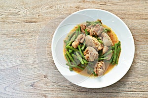 Stir fried slice yarg long bean with chicken curry sauce on plate