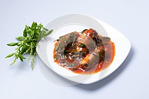 Stir-fried spicy canned fish with basil leaves served Sardines in tomato sauce fried with spicy basil. Thai style food.Clipping