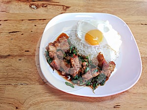 Stir fried spicy crispy pork with thai basil and fried egg.