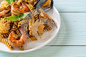 stir-fried spiral pasta with seafood and basil sauce