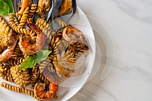 stir-fried spiral pasta with seafood and basil sauce